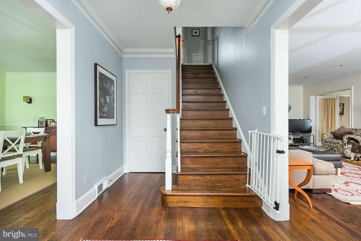 205 Longwood Road Baltimore, MD 21210 - Photo 16 of 30 a view of a hallway with wooden floor and staircase