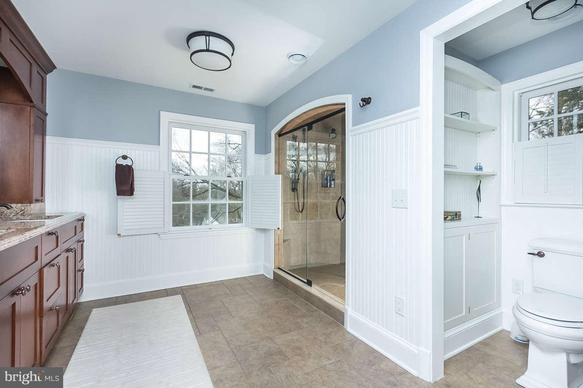 205 Longwood Road Baltimore, MD 21210 - Photo 19 of 30 a bathroom with a granite countertop sink a toilet and shower