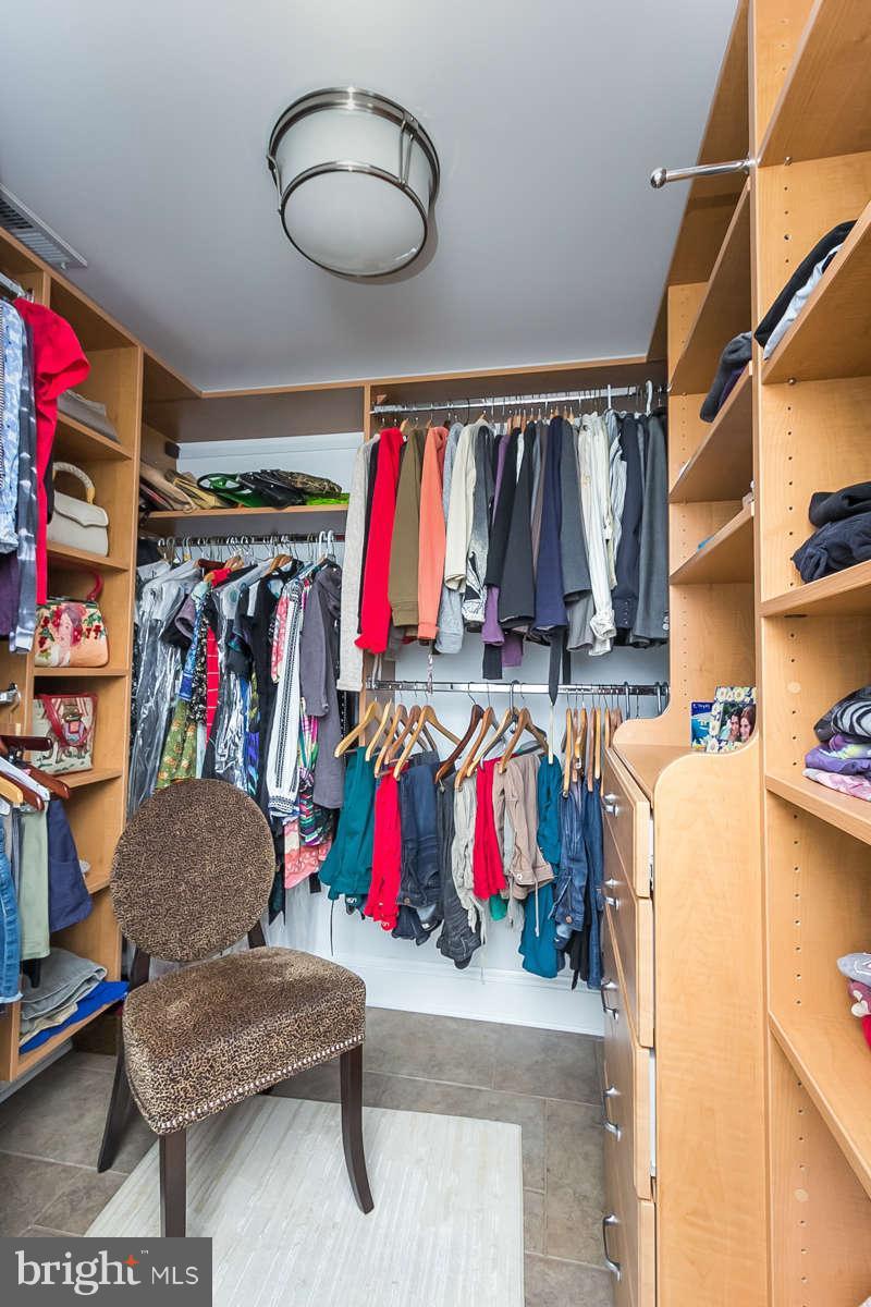 205 Longwood Road Baltimore, MD 21210 - Photo 22 of 30 a view of walk in closet with clothes and shoes