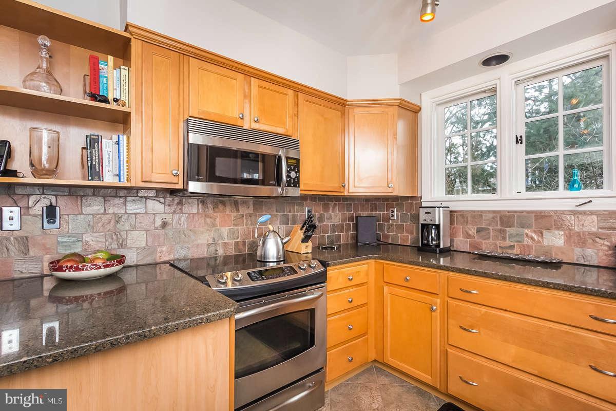 205 Longwood Road Baltimore, MD 21210 - Photo 6 of 30 a kitchen with stainless steel appliances granite countertop a sink stove top oven and cabinets