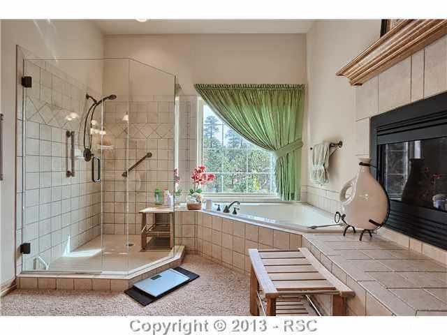 11587 Shaugnessy Road Colorado Springs, CO 80908 - Photo 11 of 24 Master spa with fireplace