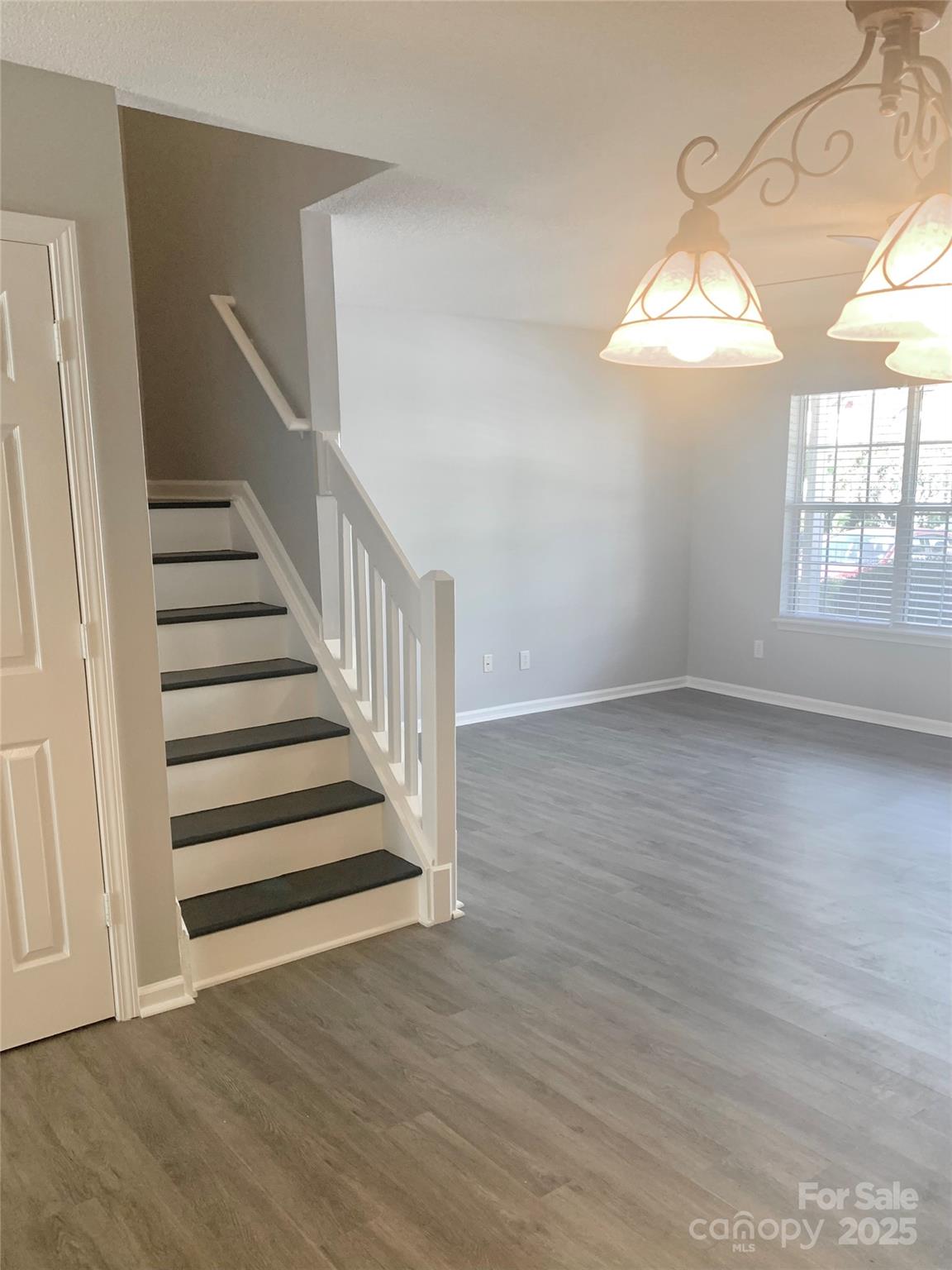 12640 Tucker Crossing Lane Charlotte, NC 28273 - Photo 15 of 36 an empty room with wooden floor and windows