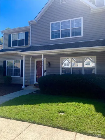 a view of house with backyard