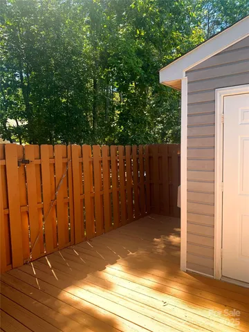 a view of backyard with wooden fence