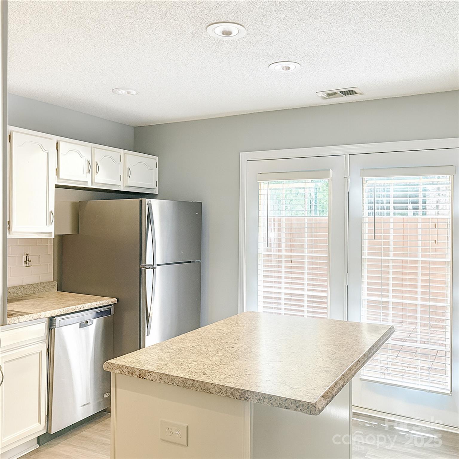 12640 Tucker Crossing Lane Charlotte, NC 28273 - Photo 7 of 36 a kitchen with refrigerator and windows