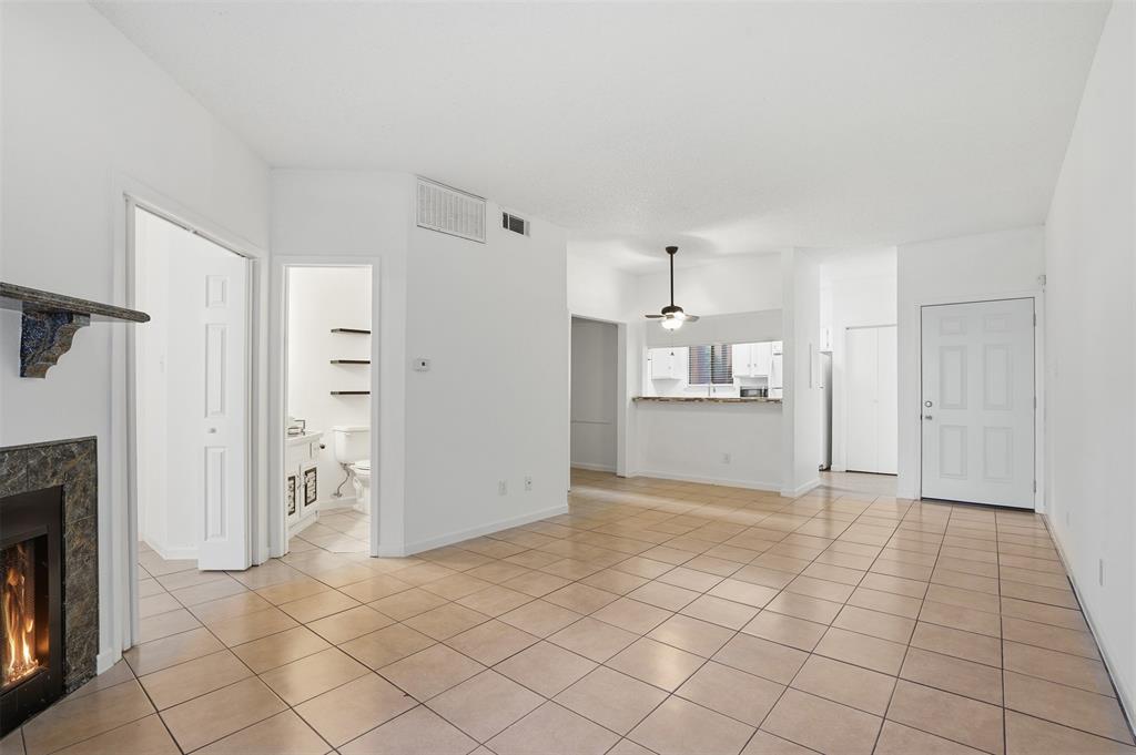5550 Spring Valley Road, Unit F14 Dallas, TX 75254 - Photo 4 of 15 a view of a kitchen with refrigerator and white cabinets
