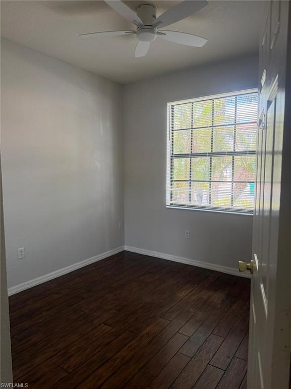7350 Bristol Circle Naples, FL 34120 - Photo 4 of 8 an empty room with wooden floor and windows