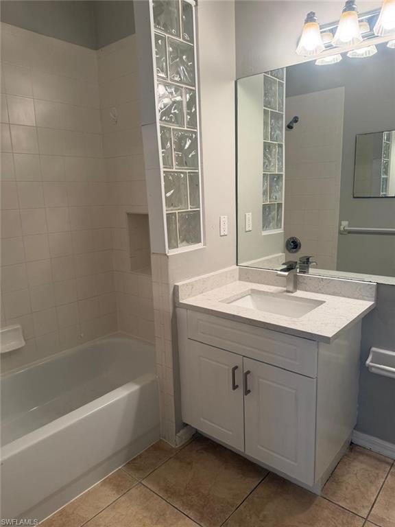 7350 Bristol Circle Naples, FL 34120 - Photo 8 of 8 a bathroom with a sink double vanity mirror and a bathtub