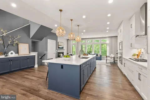 a dining room filled chandelier and wooden floor