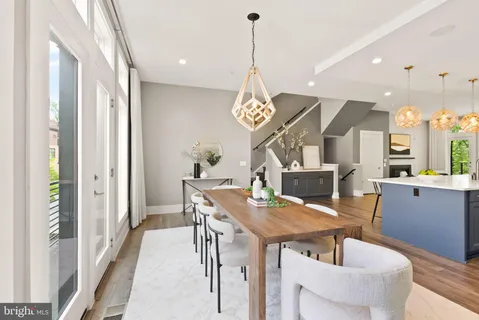 a view of a dining room with furniture wooden floor and a chandelier