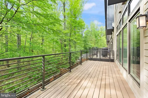 a view of balcony with wooden floor and fence