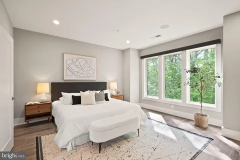 a bedroom with a large bed and a large window