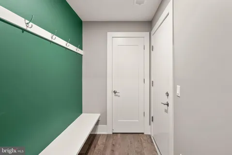 a view of a patio with couches and table and chairs with floor to ceiling window with wooden fence