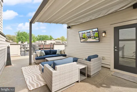 a view of outdoor kitchen with seating area