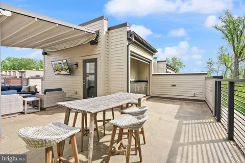 a view of a house with a yard and sitting area