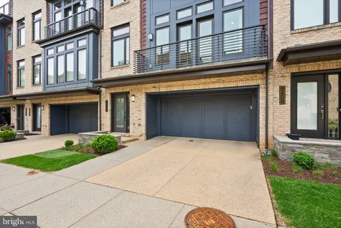 a front view of a house with a iron stairs