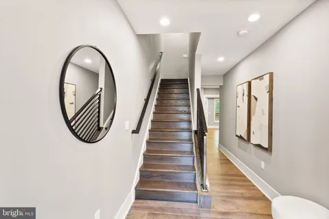 a view of entryway and hall with wooden floor