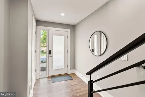 a view of a livingroom with wooden floor and a large window