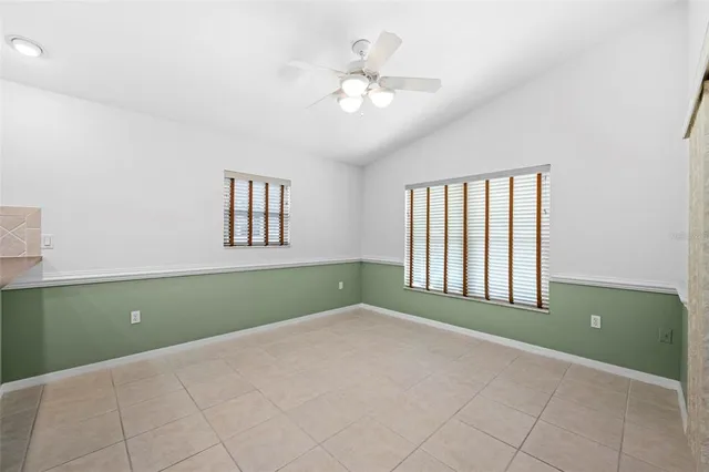 a kitchen with a refrigerator and white cabinets