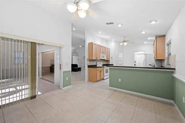 a kitchen with stainless steel appliances granite countertop a refrigerator a stove top oven a sink and dishwasher