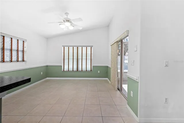 a view of a room with a large window and front door