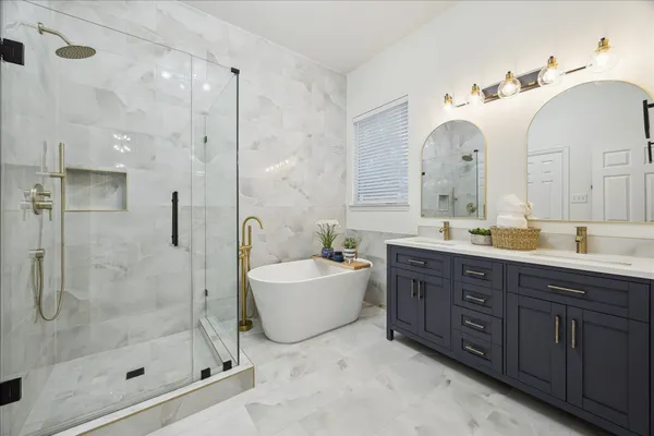 a spacious bathroom with a double vanity sink mirror and shower