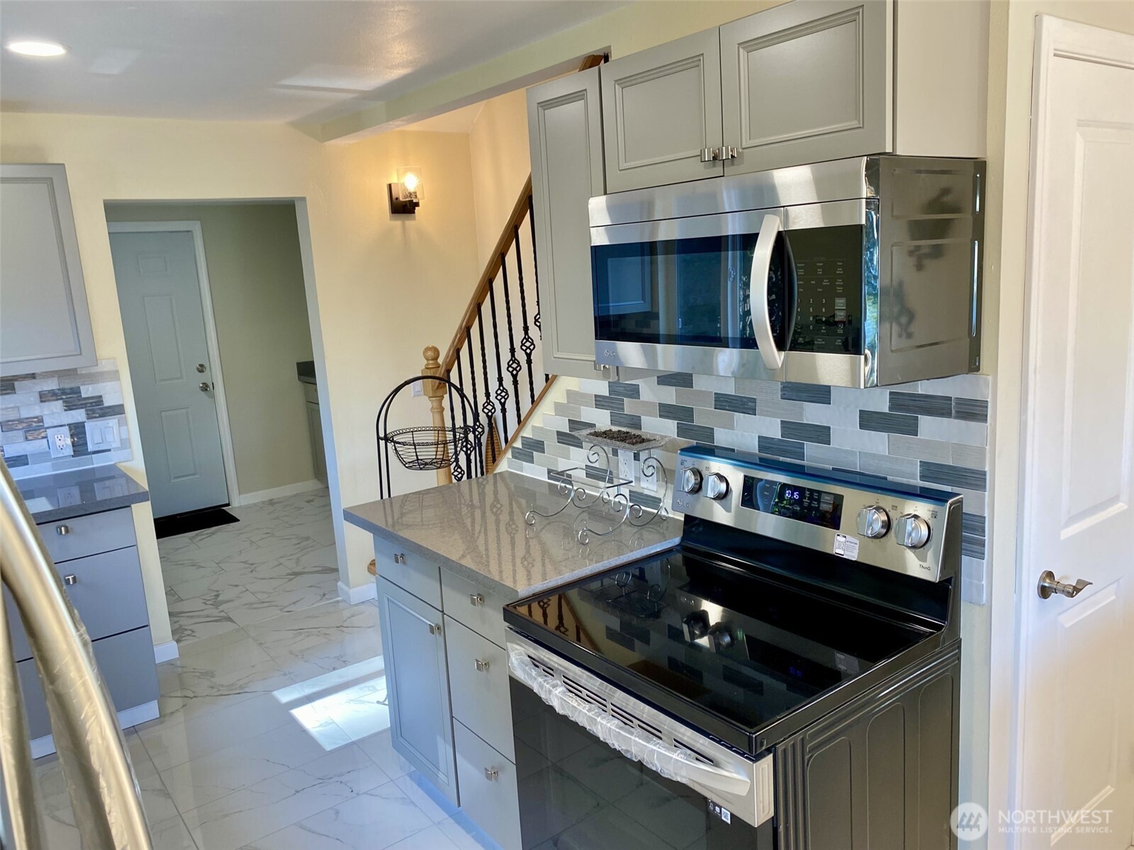 1304 Madrona Beach Road Northwest Olympia, WA 98502 - Photo 11 of 40 a kitchen with stainless steel appliances granite countertop a stove and a sink