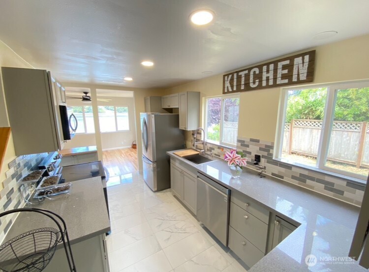 1304 Madrona Beach Road Northwest Olympia, WA 98502 - Photo 13 of 40 a large white kitchen with a large window