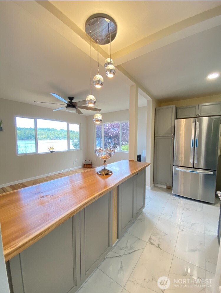 1304 Madrona Beach Road Northwest Olympia, WA 98502 - Photo 14 of 40 a kitchen with stainless steel appliances granite countertop a sink and a refrigerator