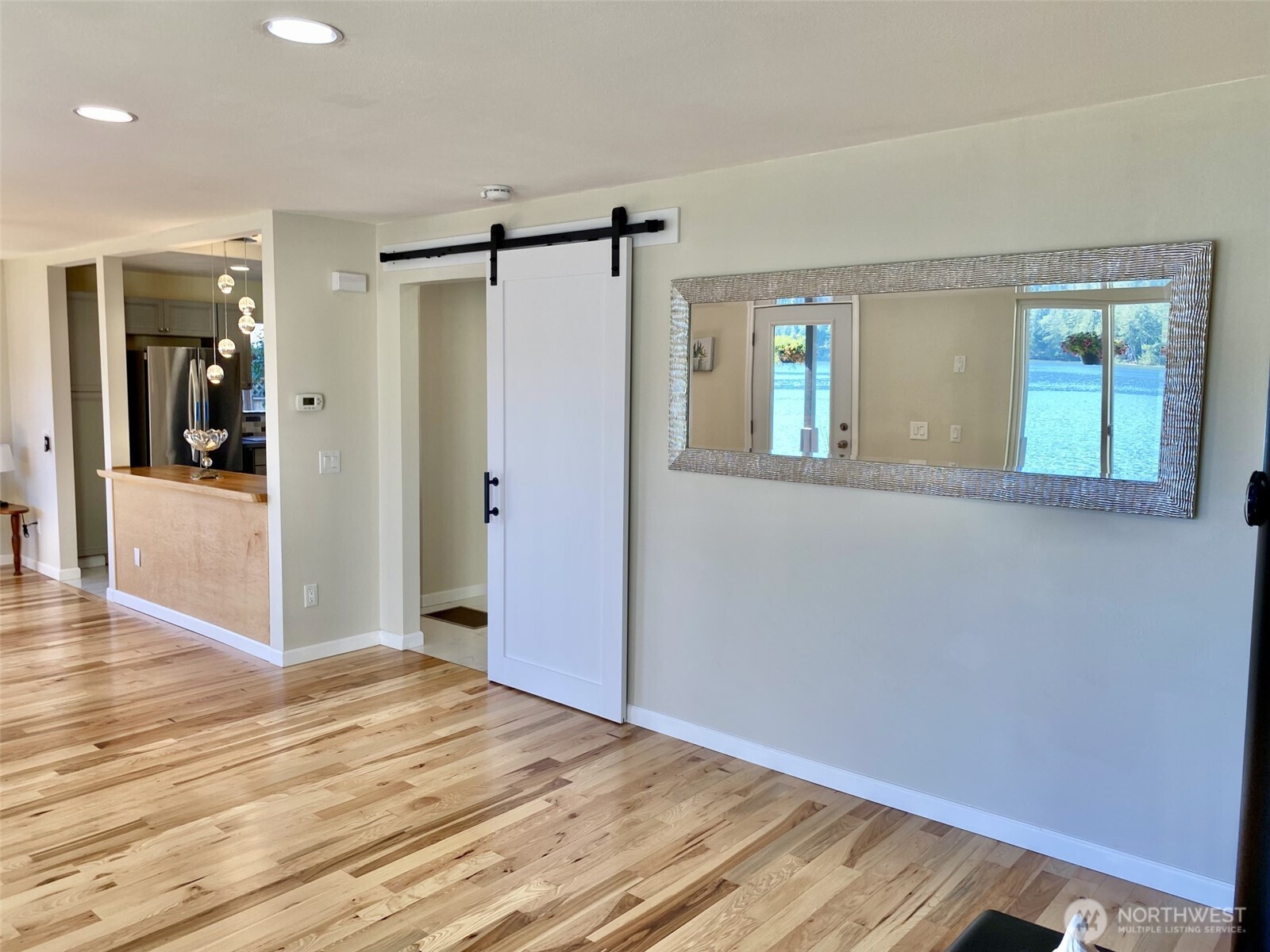 1304 Madrona Beach Road Northwest Olympia, WA 98502 - Photo 15 of 40 an empty room with wooden floor and windows