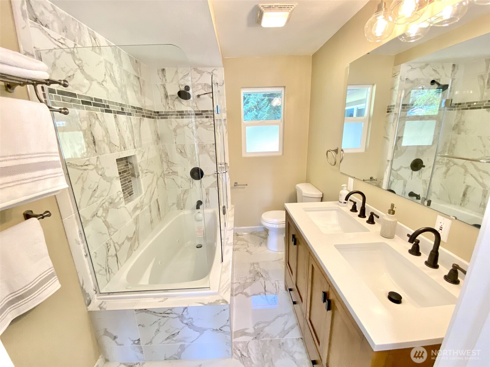 1304 Madrona Beach Road Northwest Olympia, WA 98502 - Photo 19 of 40 a bathroom with a double vanity sink mirror and shower