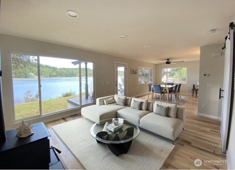1304 Madrona Beach Road Northwest Olympia, WA 98502 - Photo 2 of 40 a living room with furniture and a large window