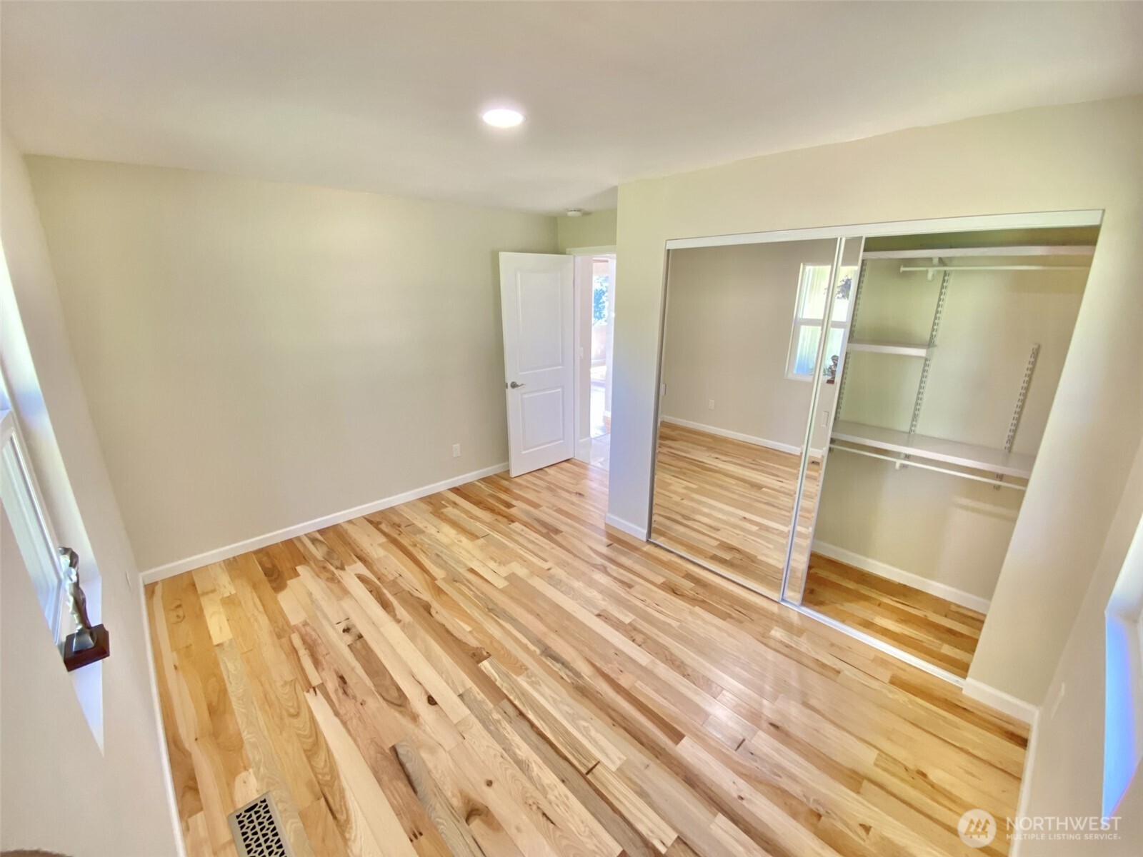 1304 Madrona Beach Road Northwest Olympia, WA 98502 - Photo 21 of 40 a view of a room with wooden floor and door