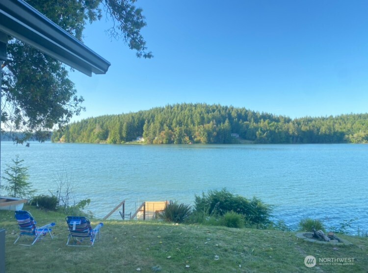 1304 Madrona Beach Road Northwest Olympia, WA 98502 - Photo 3 of 40 a view of a lake from a yard