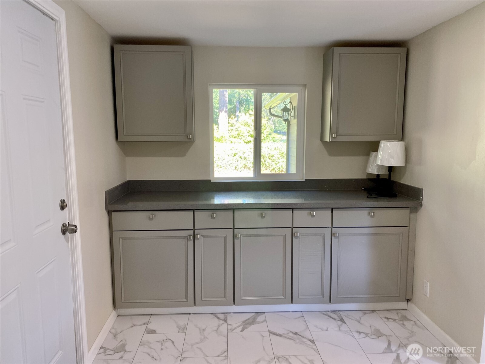 1304 Madrona Beach Road Northwest Olympia, WA 98502 - Photo 31 of 40 a kitchen with a sink and cabinets
