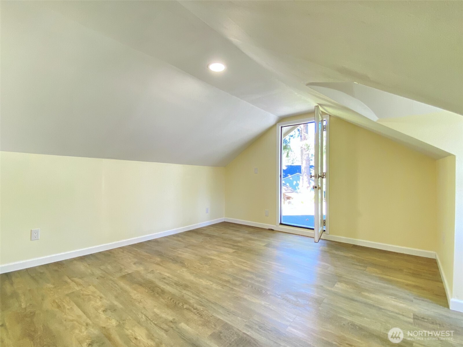 1304 Madrona Beach Road Northwest Olympia, WA 98502 - Photo 33 of 40 an empty room with wooden floor and windows