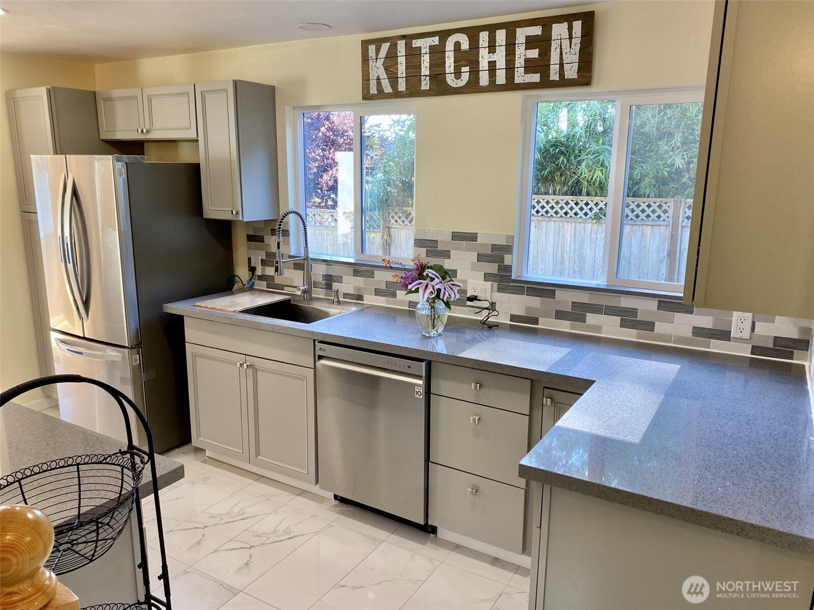 1304 Madrona Beach Road Northwest Olympia, WA 98502 - Photo 8 of 40 a kitchen with a sink cabinets and outdoor space