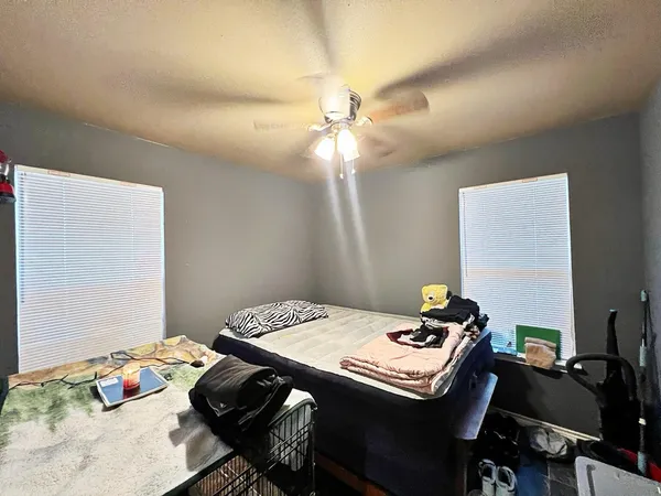 a bedroom with a bed and a table