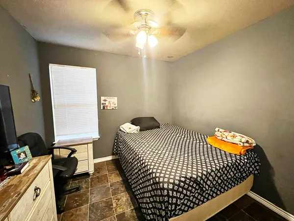 a bedroom with bed and window