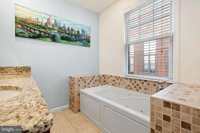a bathroom with a bathtub and a shower