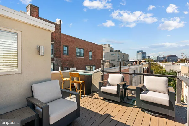 a balcony with furniture and a potted plant