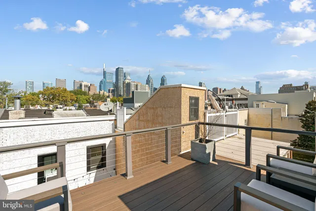 a view of a terrace with wooden floor and city view