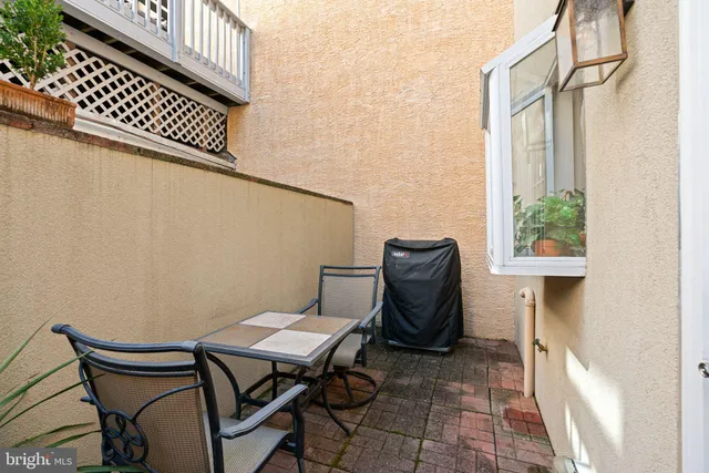 a view of a balcony with chair and potted plants