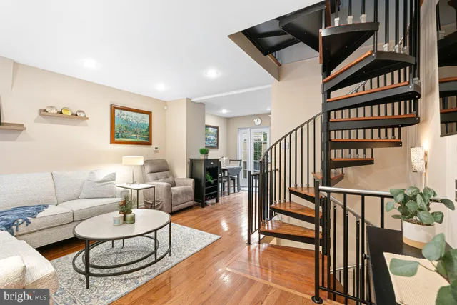 a living room with furniture and a book shelf
