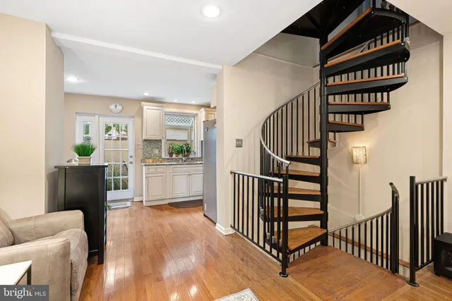 a view of entryway and hall with wooden floor