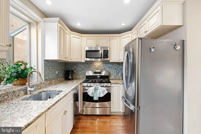 a kitchen with a refrigerator and a sink