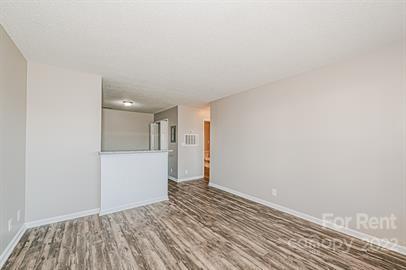 308 South Hoskins Road, Unit D Charlotte, NC 28208 - Photo 12 of 19 a view of an empty room with closet and wooden floor