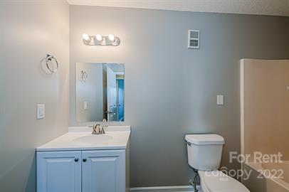 308 South Hoskins Road, Unit D Charlotte, NC 28208 - Photo 14 of 19 a bathroom with a toilet sink and mirror
