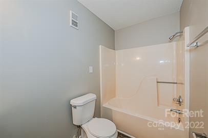 308 South Hoskins Road, Unit D Charlotte, NC 28208 - Photo 15 of 19 a white toilet sitting next to a bath tub