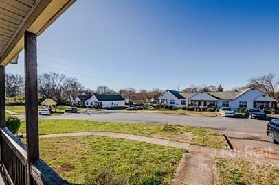 308 South Hoskins Road, Unit D Charlotte, NC 28208 - Photo 3 of 19 a view of swimming pool with lawn chairs and large trees